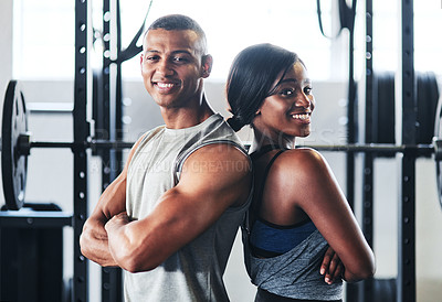 Buy stock photo Shot of two young athletes standing back to back at the gym