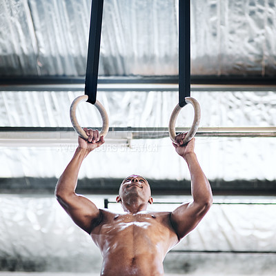 Buy stock photo Shot of a man working out with gymnastic rings
