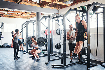 Buy stock photo Shot of a group of people working out at the gym