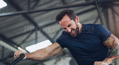 Buy stock photo Shot of a young man working out on an exercise bike in a gym