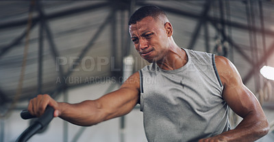 Buy stock photo Shot of a young man working out on an exercise bike in a gym