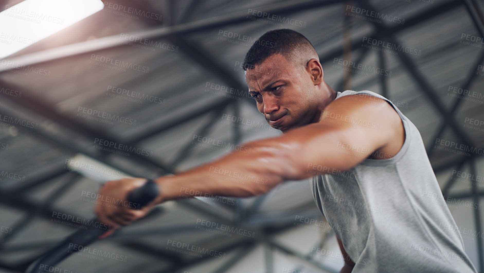 Buy stock photo Stationary bike, intense and workout with black man in gym for cardio, fitness machine and health. Cycling equipment, exercise and training with person in sports club for wellness and energy