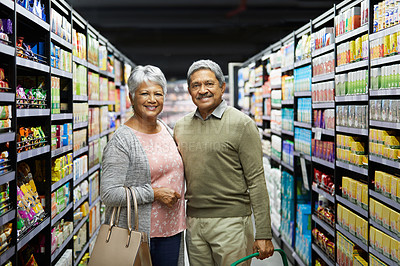 Buy stock photo Shot of a elderly couple grocery shopping in a supermarket