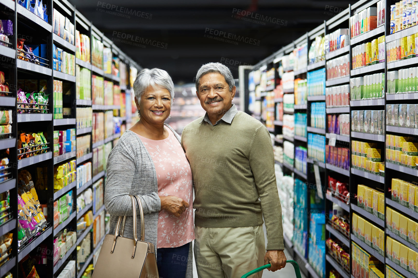 Buy stock photo Shot of a elderly couple grocery shopping in a supermarket