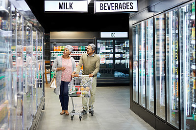 Buy stock photo Shot of a elderly couple grocery shopping in a supermarket