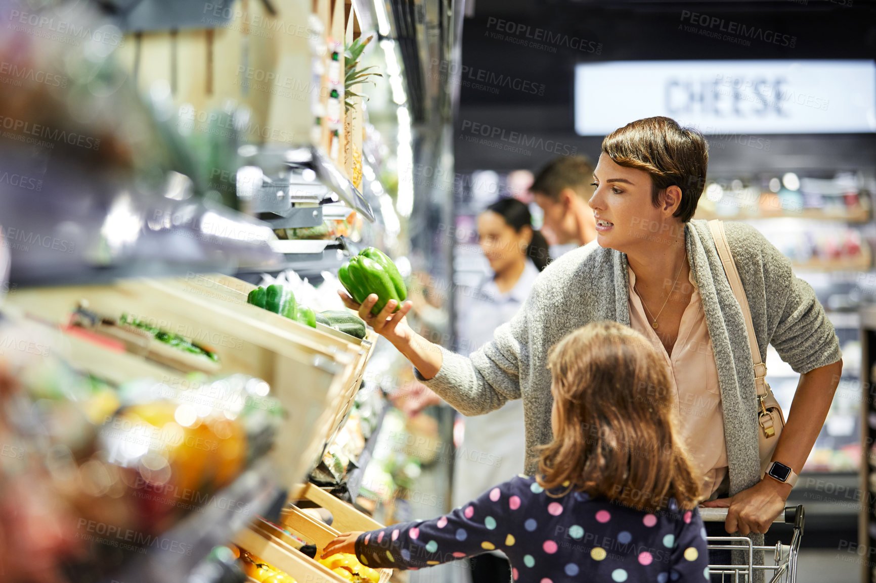 Buy stock photo Mom, vegetable or child in supermarket aisle for grocery shopping, food or organic supplies. Mother, kid or daughter with green pepper in convenient store for natural ingredients or sustainability
