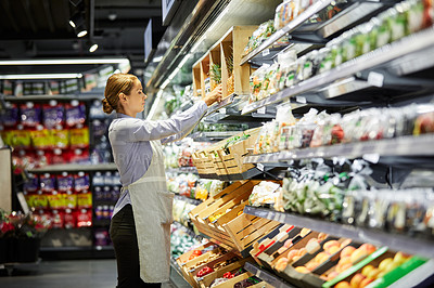 Buy stock photo Shot of a young woman working in a supermarket