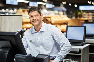 Buy stock photo Shot of a man working as a cashier at a supermarket