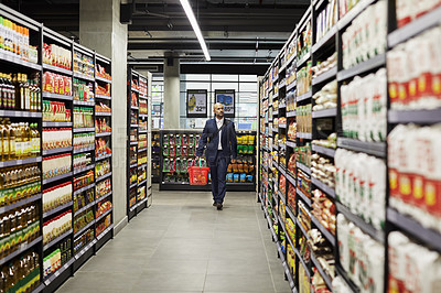 Buy stock photo Shot of a mature male shopping for groceries in a supermarket