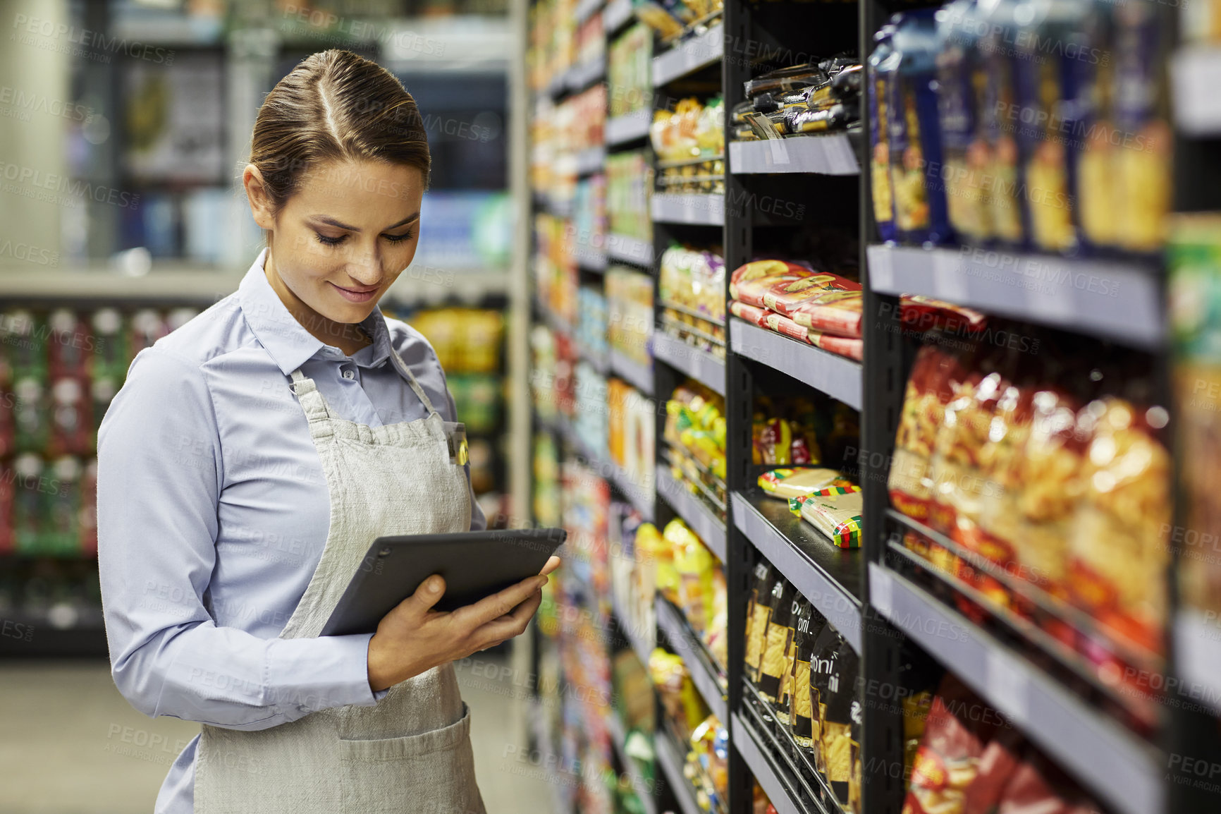 Buy stock photo Aisle, inventory and woman with tablet in supermarket for storage inspection or stock management. Female person, packer or store clerk with technology for product checklist, shop or essential service