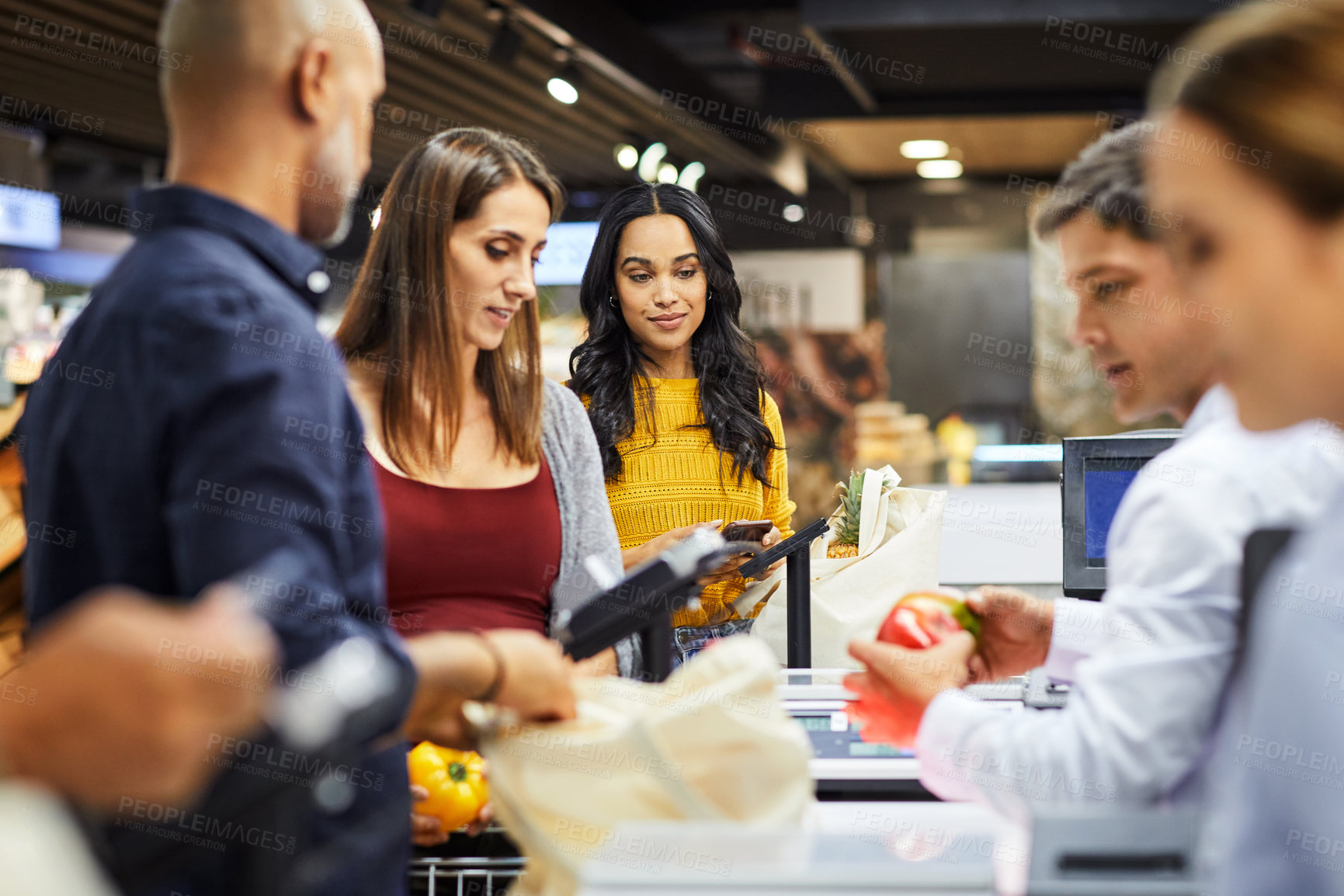 Buy stock photo 4k video footage of a group of people paying for the groceries at a till