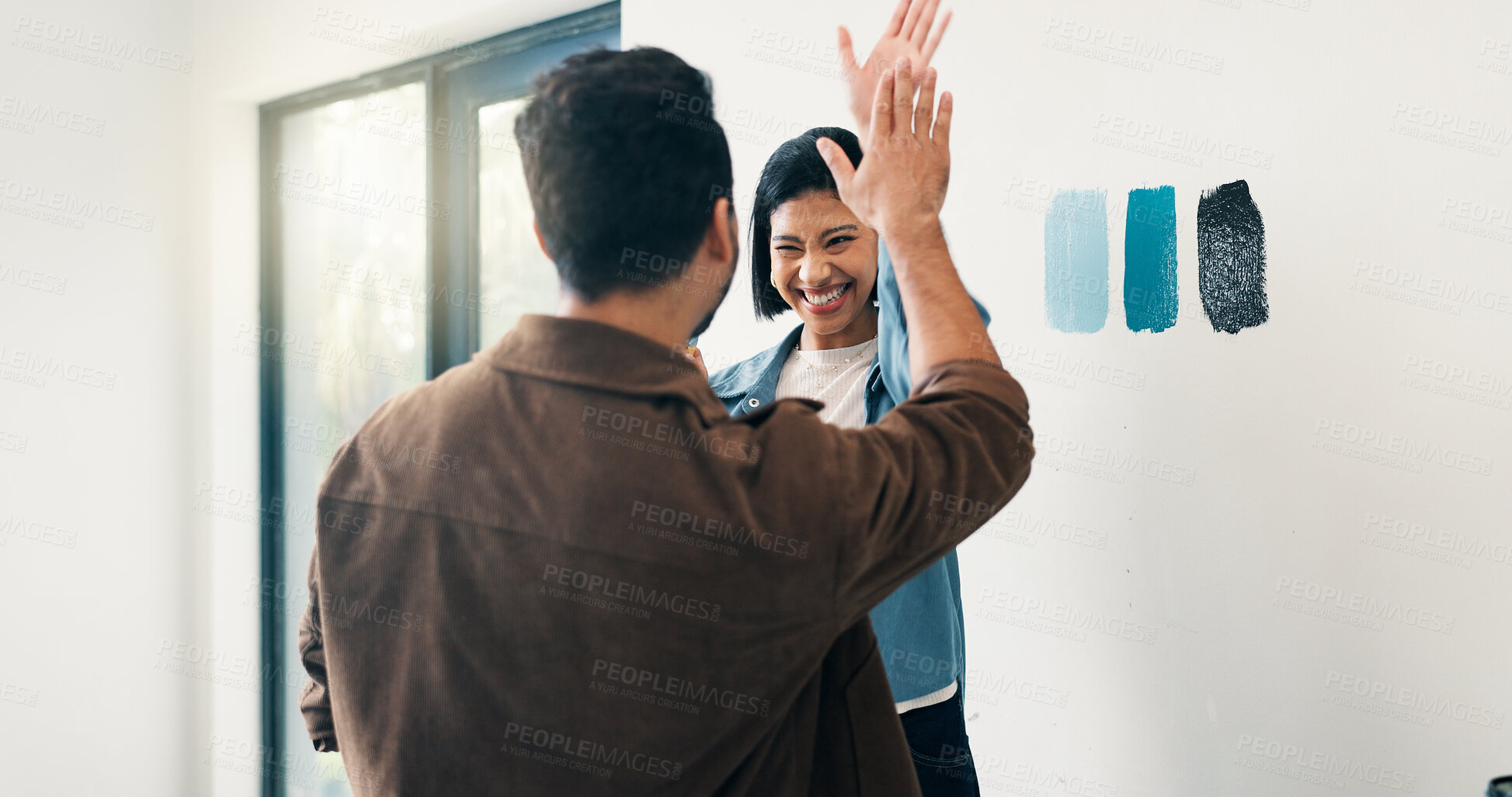 Buy stock photo High five, paint and choice with couple in home for diy project, remodeling or renovation success. Color palette, compare or decision with excited people for apartment makeover, motivation or support