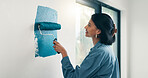 Painting, woman and happy with wall renovation for living room makeover, home upgrade or maintenance. Interior design, homeowner and smile with paintbrush for house improvement, change and diy decor