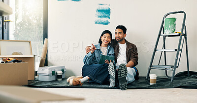 Buy stock photo DIY, pointing and tablet with couple renovation on floor for discussion or project planning. Hug, home improvement and decor app with people in new house for construction or interior design decision