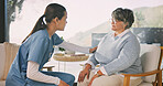 Senior, woman or discussion with nurse for assisted living, healthcare or help in retirement house. Female person, caregiver or talking with patient for elderly care, checkup or visit in nursing home