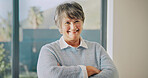 Smile, arms crossed and senior woman in home for relax, wellness and peace on staycation. Portrait, retirement and happy person with confidence at apartment, positive attitude and calm with pride