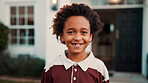 New home, portrait and smile of boy outdoor in front yard for future, neighborhood or security. Property, real estate and relocation with happy black child in garden for fresh start or moving in