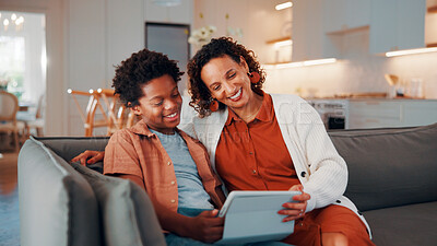 Buy stock photo Mother, child and reading in home with tablet, ebook and smile for knowledge growth on weekend break. Happy, African woman and son in living room with tech, online story and learning for development.