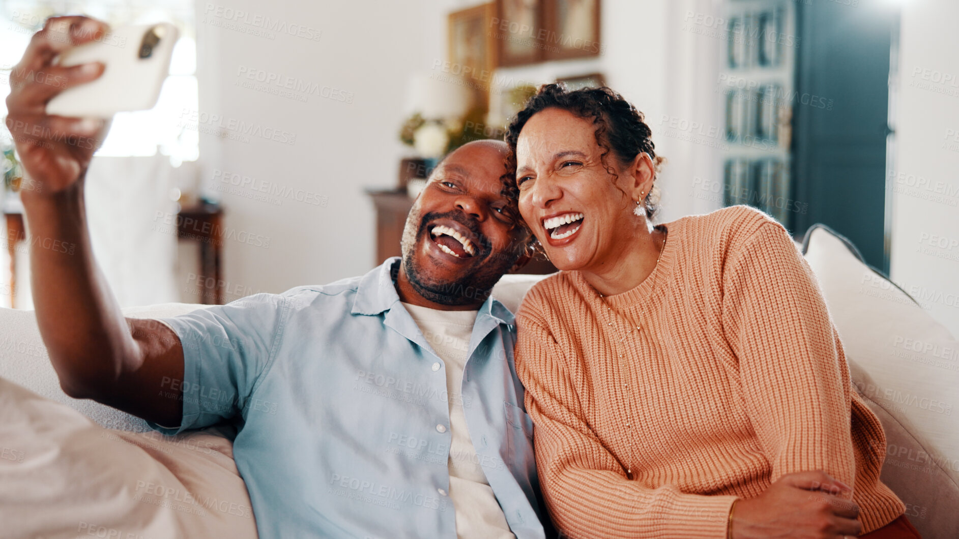 Buy stock photo Laughing, love and selfie with couple on sofa in home living room together for bonding or memories. Funny, photograph and relax with happy people in apartment for connection or social media post