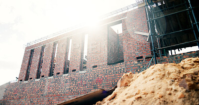 Buy stock photo Building, construction site and flare with scaffolding for renovation, architecture and property upgrade. Sunshine, worksite and residential improvement for real estate development with expansion