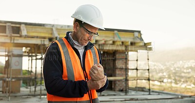 Buy stock photo Engineer, man and wrist pain on construction site with injury, building accident and risk strain. PPE, mature person and hurt hand or fatigue with civil engineering error, sprain and overworked