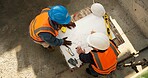 Team, blueprint and engineer at construction site for discussion, development review or layout above. Top view, people and document for architecture design, building planning or strategy evaluation