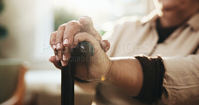 Buy stock photo Hands, retirement and walking stick with old person in home for balance, rehabilitation or wellness. Arthritis, cane and senior woman with disability in living room of apartment for break or healing
