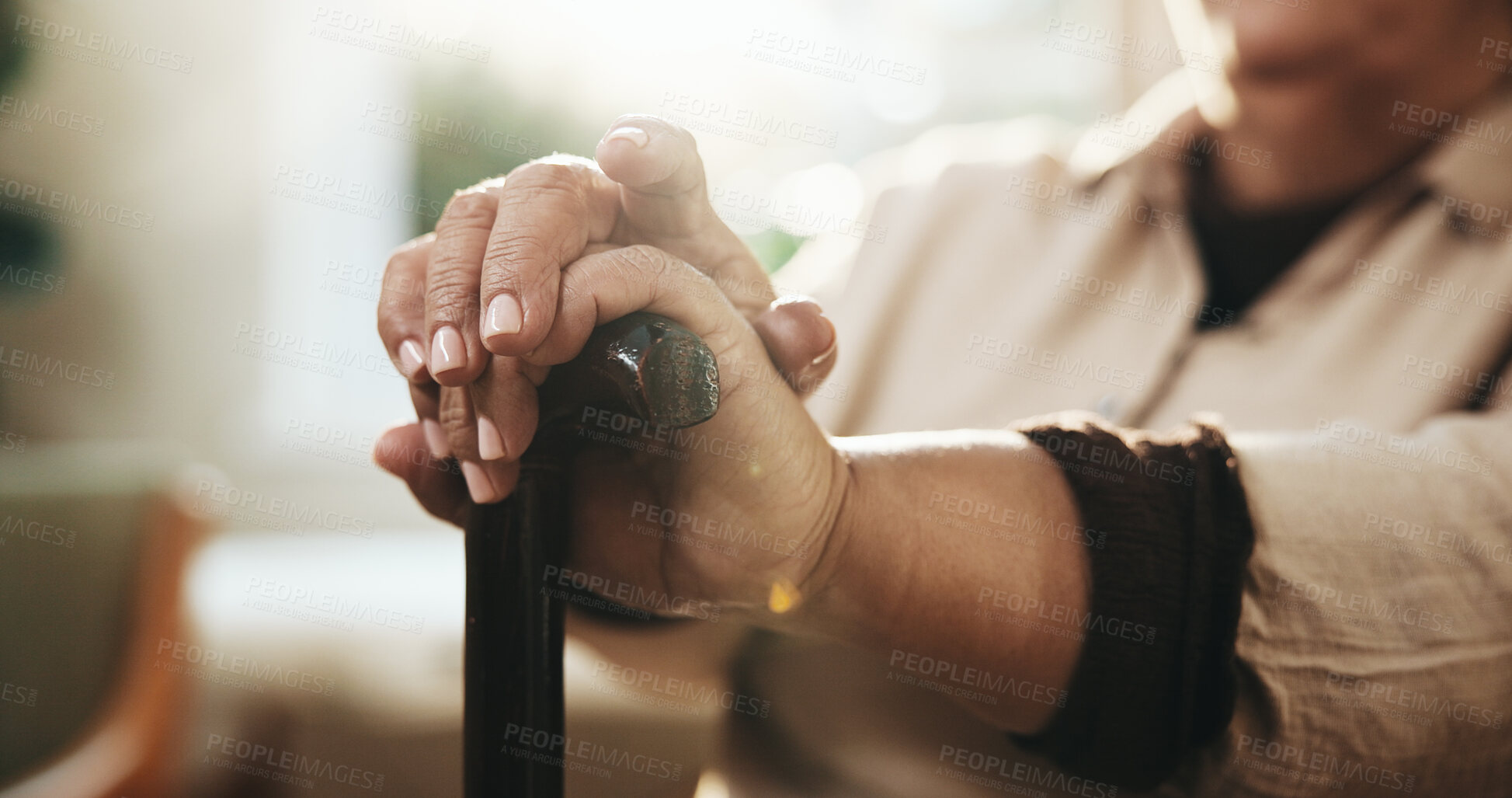 Buy stock photo Hands, retirement and walking stick with old person in home for balance, rehabilitation or wellness. Arthritis, cane and senior woman with disability in living room of apartment for break or healing