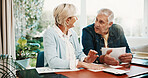 Happy, finance and senior couple in home for budget planning, mortgage payment or bills. Marriage, retirement and man with woman with savings, financial report or talking for expenses or pension fund