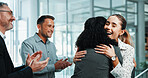 Business people, woman and applause in office for hug, positive reinforcement and promotion. Employee, winner and happy in lobby for career growth, successful campaign or achievement with smile