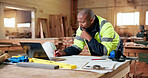 Carpentry, thinking and writing with black man in workshop for agenda, checklist or online order. Computer, documents and planning with mature carpenter in woodworking factory for digital schedule