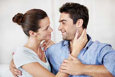 Buy stock photo Smile, couple and relax at house with love, affection and support for bonding together. Happy, people and rest in living room with embrace, admiration and marriage connection for healthy relationship