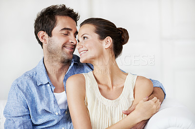 Buy stock photo Love, peace and smile with couple on sofa in home for bonding, support and weekend break. Happy, connection and commitment with man and woman in living room of house for marriage, care and loyalty