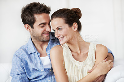 Buy stock photo Love, care and happy with couple on sofa in home for bonding, support and weekend break. Smile, connection and commitment with man and woman in living room of house for marriage, relax and loyalty