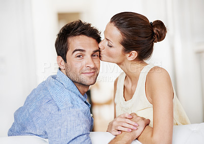 Buy stock photo Love, kiss and care with couple on sofa in home for bonding, support and weekend break. Happy, connection and commitment with portrait of man and woman in living room for marriage and loyalty