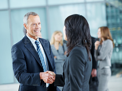 Buy stock photo Business, man and handshake greeting in lobby for networking, partnership and workshop break. Global expo, mature person or shaking hands at event for headhunting, professional connection or seminar