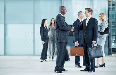 Buy stock photo Business, people and handshake greeting in lobby for networking, introduction and seminar break. Global conference, men and shaking hands at event for headhunting, professional connection and space