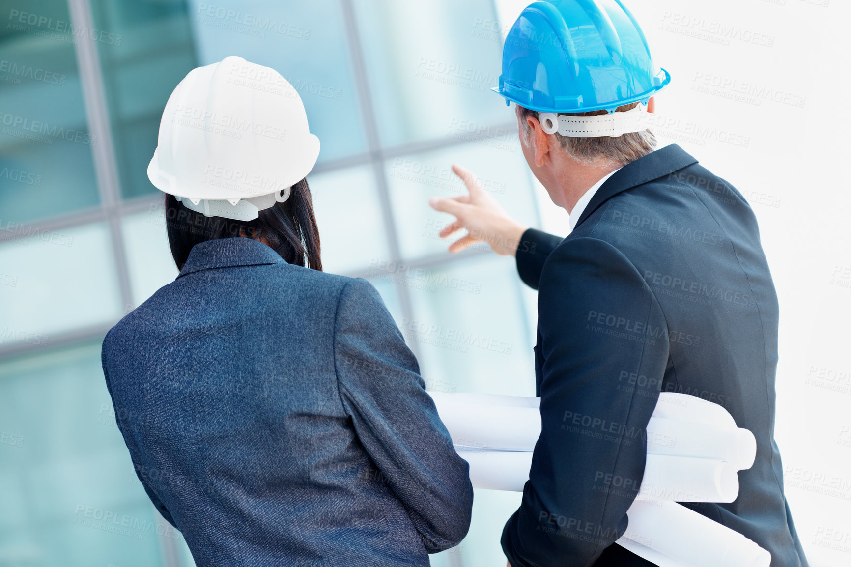 Buy stock photo Engineer, pointing and back of business people with blueprint for architecture, meeting and team. Construction project, building inspection and floor plan with employees for property developer