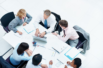 Buy stock photo Above, business people and laptop in conference room, finance team and budget overview discussion. Group, collaboration and paperwork with pc for financial plan, revenue or expenses agenda in meeting