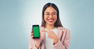 Buy stock photo Pointing, green screen and businesswoman with cellphone in studio for advertising finance app. Happy, portrait and financial advisor with mockup space on phone for internet banking on blue background
