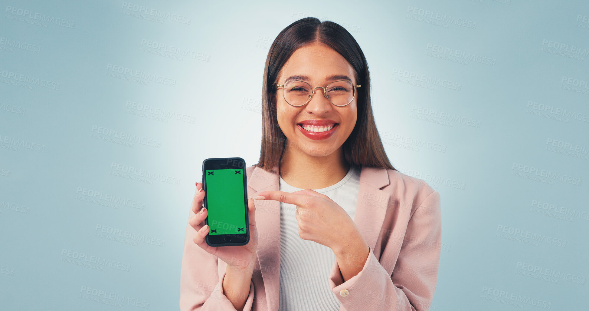 Buy stock photo Pointing, green screen and businesswoman with cellphone in studio for advertising finance app. Happy, portrait and financial advisor with mockup space on phone for internet banking on blue background