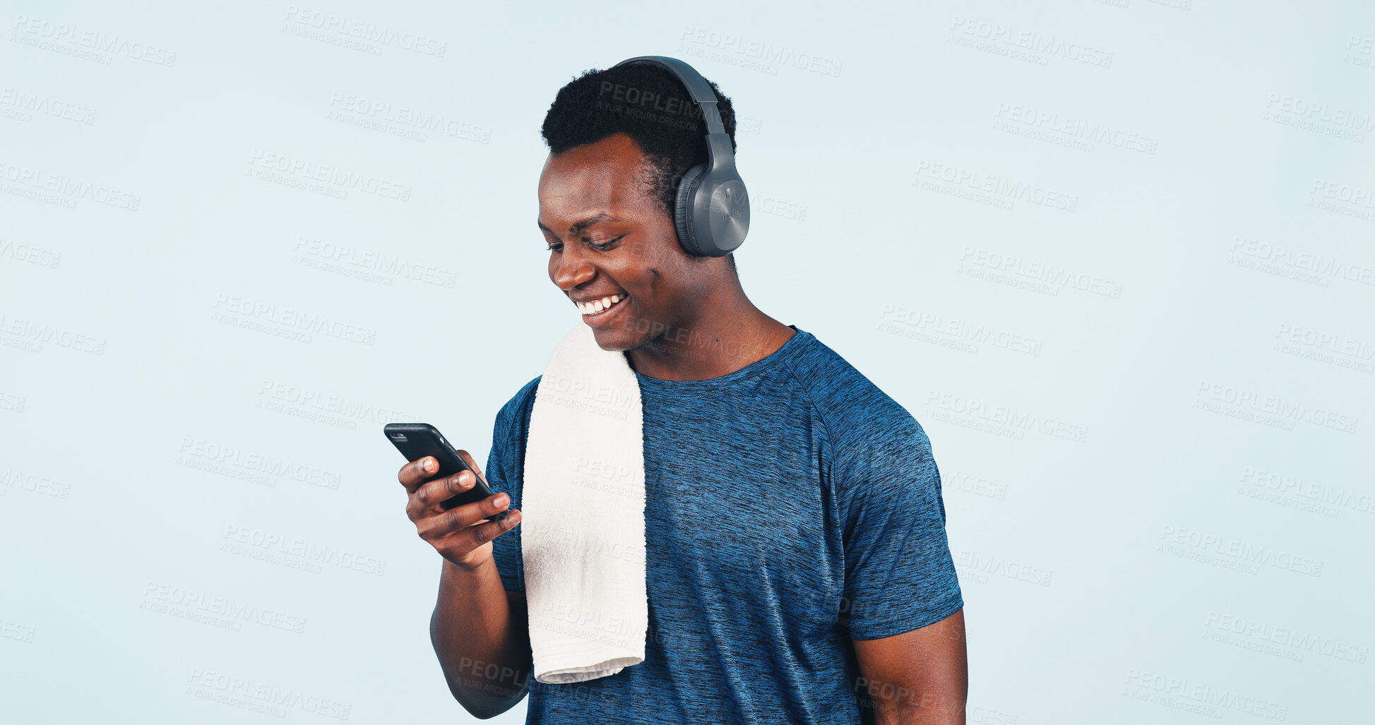 Buy stock photo Fitness, music and phone with black man in studio for health tracking or progress report. App, headphones and space with happy person streaming audio on background for development or exercise