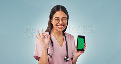 Buy stock photo Green screen, perfect and face of nurse with phone in studio for medical research or telehealth. Happy, woman and portrait of healthcare worker with mockup space on technology by blue background.