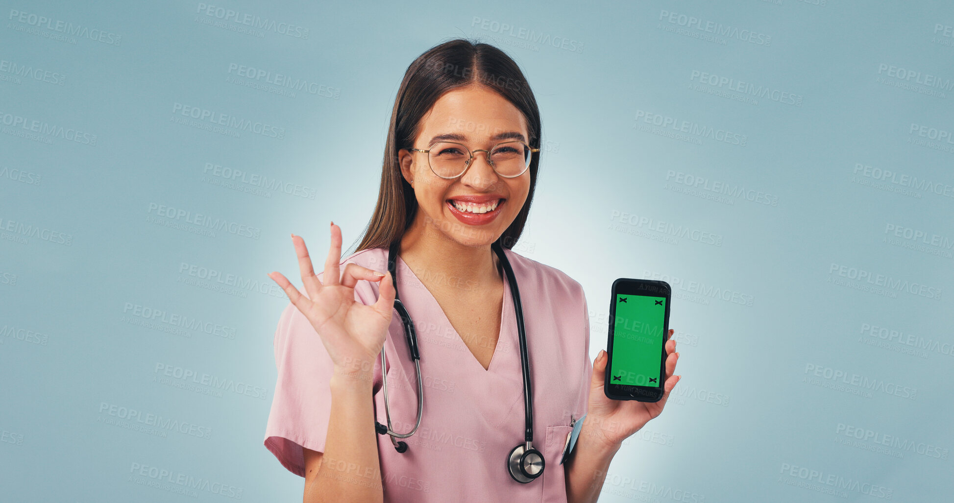 Buy stock photo Green screen, perfect and face of nurse with phone in studio for medical research or telehealth. Happy, woman and portrait of healthcare worker with mockup space on technology by blue background.