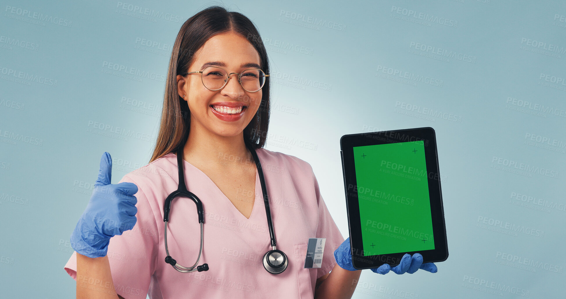 Buy stock photo Nurse, portrait or thumbs up with tablet green screen for advertising on a blue studio background. Happy, female person or healthcare worker with technology display for app, UI or UX on mockup space