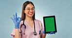 Green screen, perfect and face of nurse with tablet in studio for medical research or telehealth. Happy, woman and portrait of healthcare worker with ok gesture for technology on blue background.