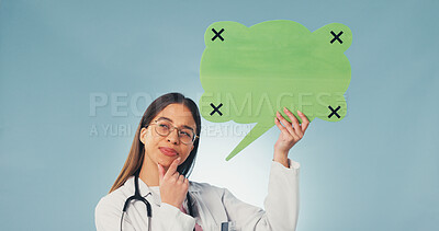 Buy stock photo Woman, thinking and doctor with speech bubble in studio with mockup space for medical advertising. Planning, social media and healthcare worker on blue background with poster or board for marketing.