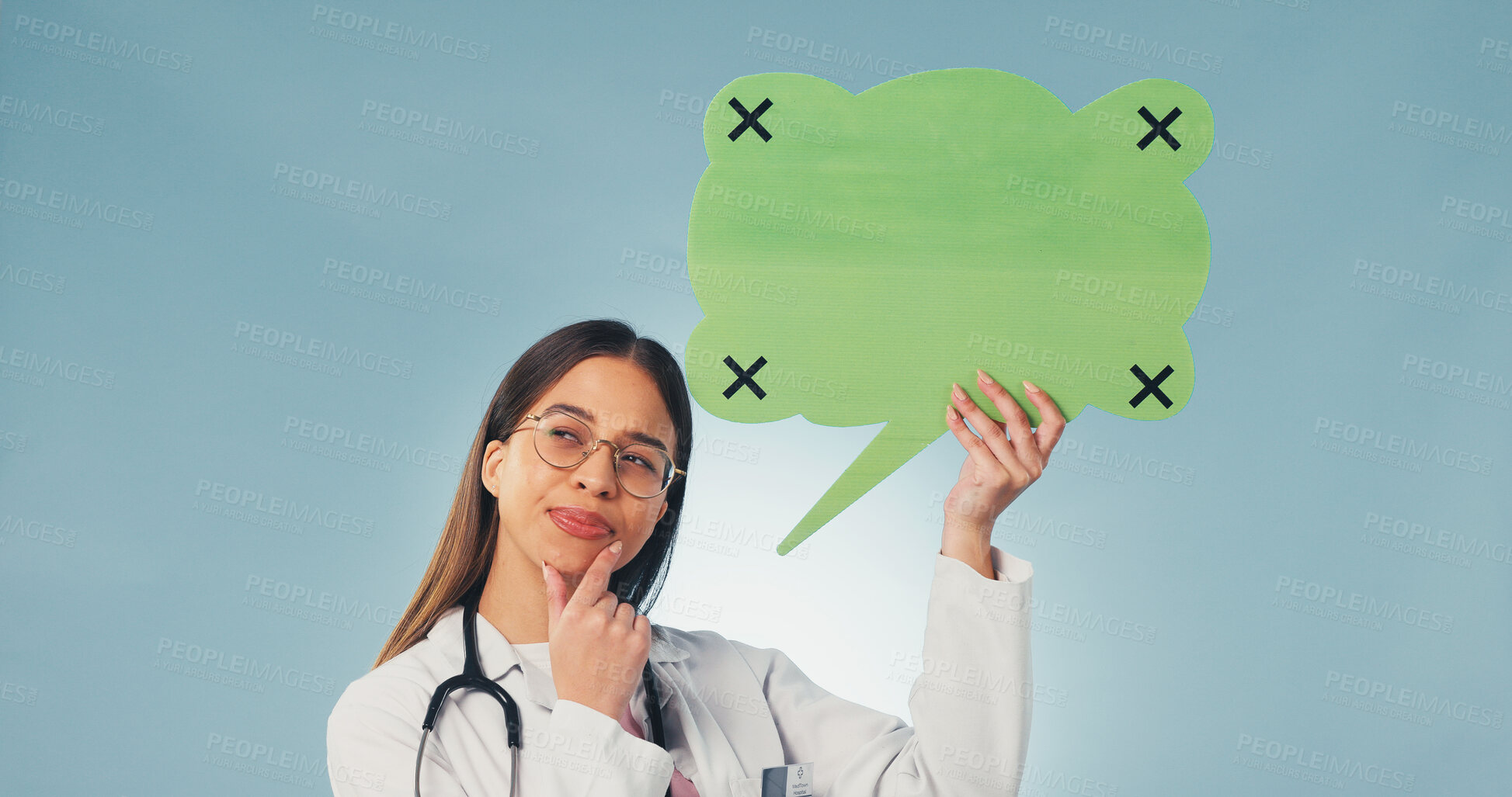 Buy stock photo Woman, thinking and doctor with speech bubble in studio with mockup space for medical advertising. Planning, social media and healthcare worker on blue background with poster or board for marketing.