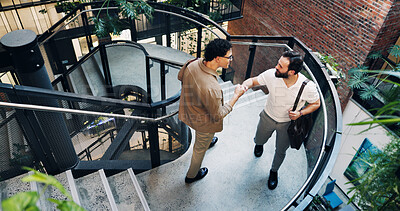 Buy stock photo Above, handshake and business men on stairs in office for sustainability deal, agreement or partnership. Welcome, steps and ESG manager shaking hands with client for contract on habitat restoration.