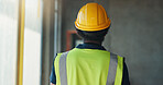Man, back and inspection for construction, contractor compliance or progress on site with helmet. Safety manager, maintenance and quality assurance for renovation, engineering or project management